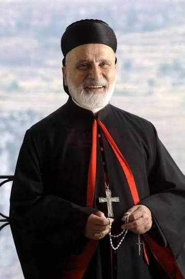 Portrait of Maronite Patriarch Nasrallah Boutros Sfeir in black and red clerical robes with a pectoral cross.