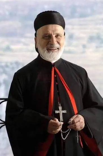Portrait of Maronite Patriarch Nasrallah Boutros Sfeir in black and red clerical robes with a pectoral cross.